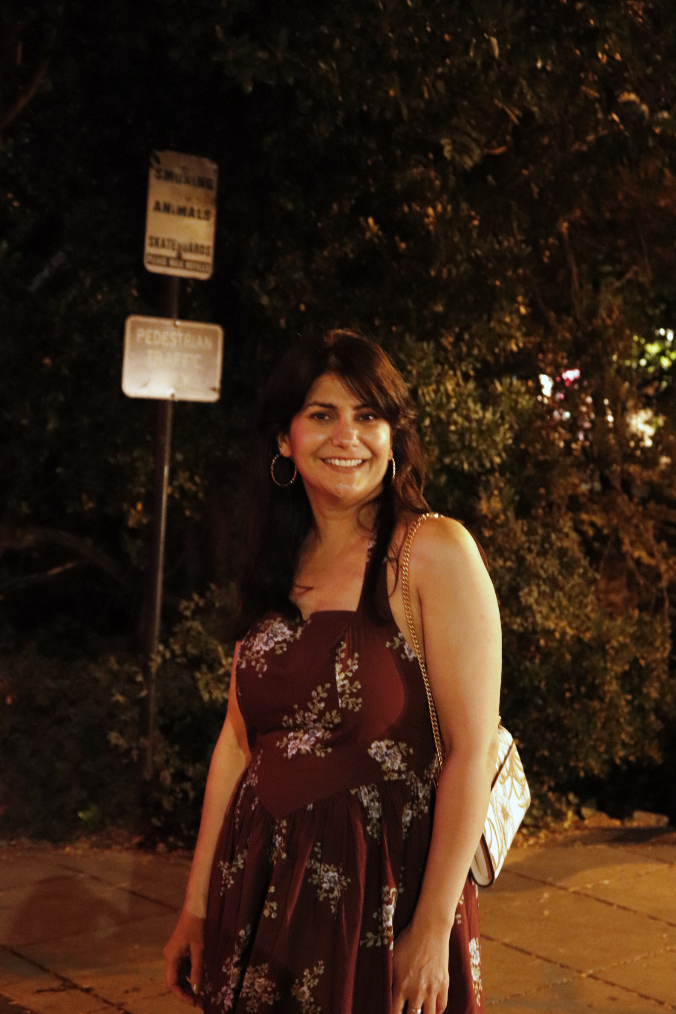 Moon Sheoran outdoors in a floral dress in the evening
