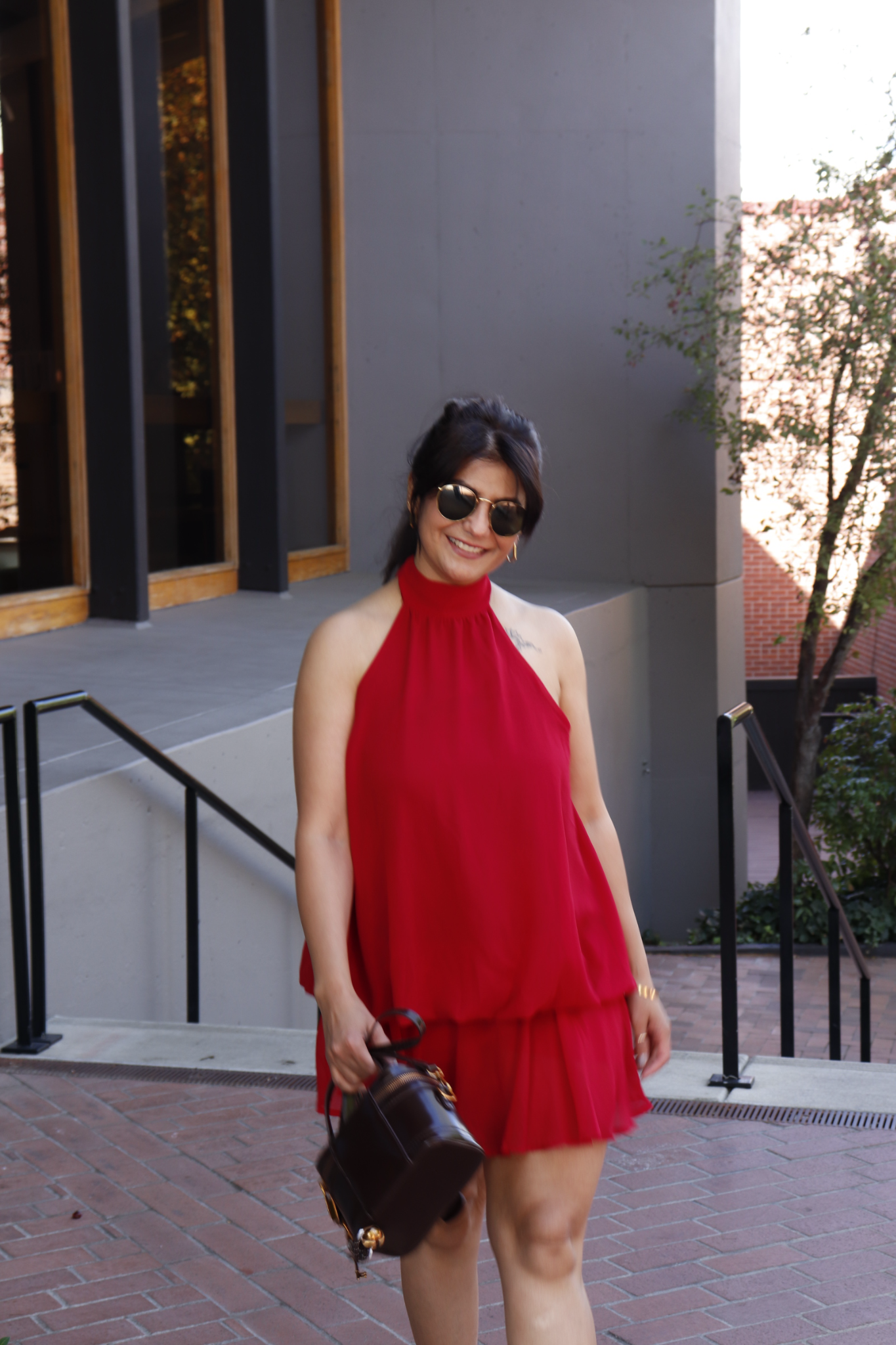 Moon Sheoran wearing a red dress outdoors