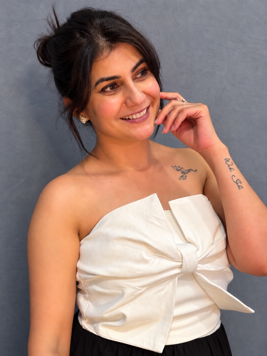 Moon Sheoran smiling in an elegant white bow top
